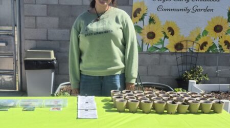 ESRCD staff smiling behind table
