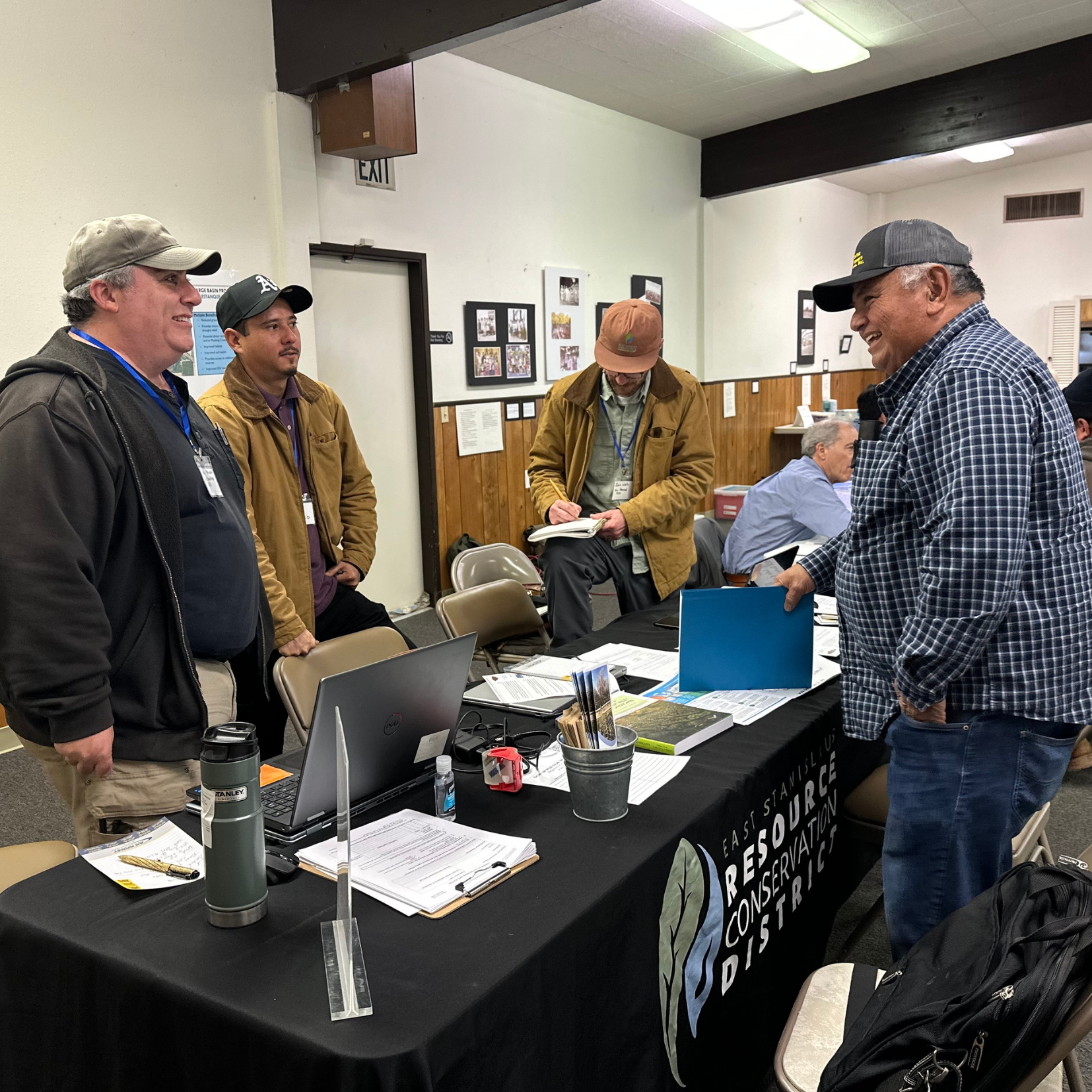 ESRCD Staff, Chris Yohanan, and Gonzo Garcia assisting a local farmer at a technical assistance fair.